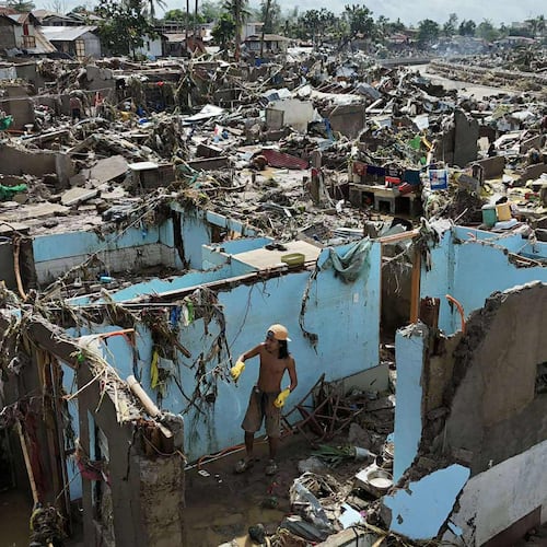 A resident returns to what remains of their home after Typhoon Kalmaegi devastated communities along the Mananga River in Talisay City, Cebu province, central Philippines, Wednesday, Nov. 5, 2025. (AP Photo/Jacqueline Hernandez)