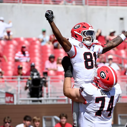 Georgia wide receiver Craig Dandridge (81) celebrates with teammates Drew Bobo (74) and Gunner Stockton (14) after a touchdown catch against Arkansas during the second half of an NCAA college football game Saturday, Sept. 19, 2026, in Fayetteville, Ark. (AP Photo/Michael Woods)