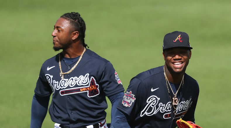 022421 North Port: Atlanta Braves second baseman Ozzie Albies (left) and outfielder Ronald Acuna share a laugh in shallow right field after avoiding the collision while calling a fly ball during team practice at CoolToday Park on Wednesday, Feb. 24, 2021, in North Port. Curtis Compton / Curtis.Compton@ajc.com”