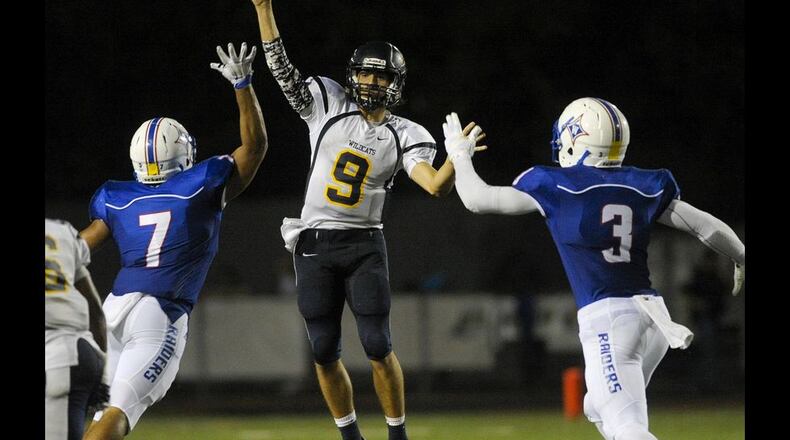 Septermber 18, 2015 Marietta, Ga. — Wheeler junior QB Gabe Magerkurth (9) makes a pass as Walton linebacker Garett Eldred (7) and defensive end Josh White (3) attempt to block during the second half of play at Walton High Friday, September 18, 2015. Special/Daniel Varnado