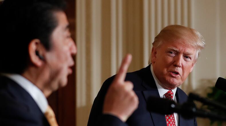 President Donald Trump listens Japanese Prime Minister Shinzo Abe speaks during a joint new conference in the East Room of the White House, in Washington, Friday, Feb. 10, 2017. (AP Photo/Carolyn Kaster)