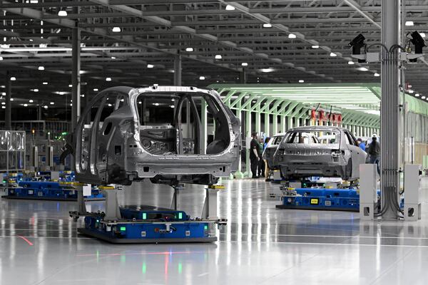 Hyundai IONIQ electric vehicle frames move along the stamping and welding line at the automaker's southeast Georgia plant on Wednesday, May 6, 2026. Hyundai Metaplant behind. (Hyosub Shin/AJC)