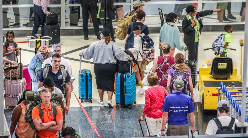 July 5, 2022 Hartsfield-Jackson International Airport: Airline travelers on the North Domestic Terminal made their way through Hartsfield-Jackson International Airport at the domestic terminal on Tuesday, July 5, 2022 after managing through a busy Fourth of July weekend for air travel with storms and cancellations, airlines face the challenge of navigating through the rest of a busy summer. Pilot unions, travelers and Atlanta-based Delta Air Lines had raised concerns about staffing issues and flight disruptions over the holiday weekend. Delta ended up canceling dozens of flights a day throughout the weekend, as did other major carriers as thunderstorms hit Georgia and the East coast. But the Independence Day weekend flight cancellations weren’t as severe as during Memorial Day weekend and some other nightmare travel days so far this summer. On Friday, the busiest day of the holiday weekend, Delta canceled 117 flights, or 3.9% of scheduled flights according to FlightAware.com. On Saturday, it canceled 81 flights, followed by 54 cancellations on Sunday and 41 cancellations on Monday. Fort Worth, Texas-based American Airlines and Delta have had the worst cancellation rates in the U.S. airline industry in recent weeks, according to FlightAware.com data. (John Spink / John.Spink@ajc.com)