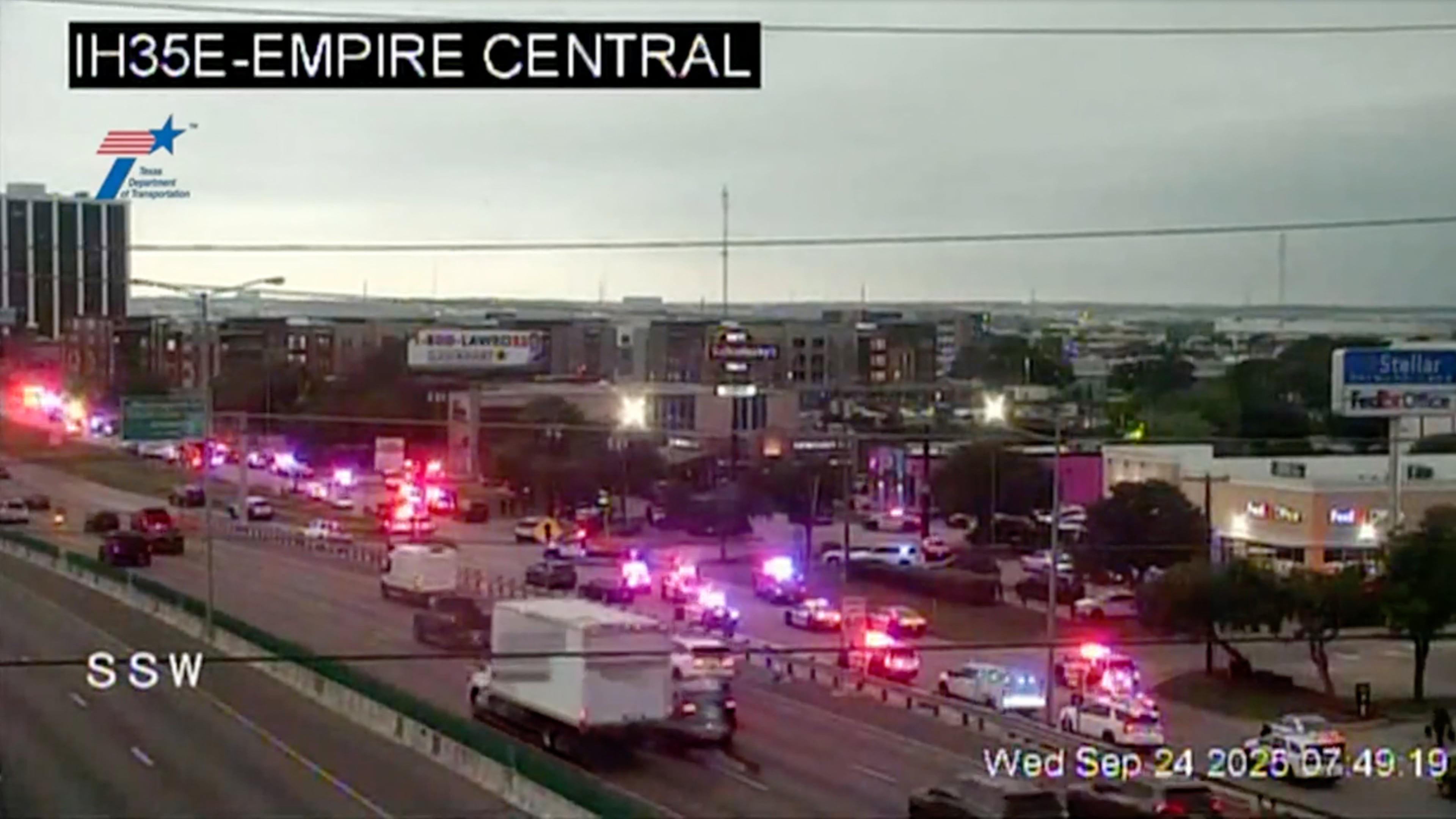 This traffic camera image shows heavy police presence off I-35E close to a U.S. Immigration and Customs Enforcement office, in northwest Dallas on Thursday, Sept. 24, 2025. (WFAA via AP)