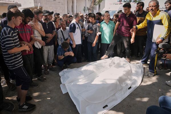 Palestinians gather around the bodies of Dr. Marwan Sultan the director of the Indonesian Hospital in the northern Gaza Strip, his wife, daughter, and son in law, after they were killed in an Israeli airstrike, at Shifa Hospital in Gaza City Wednesday, July 2, 2025. (AP Photo/Jehad Alshrafi)