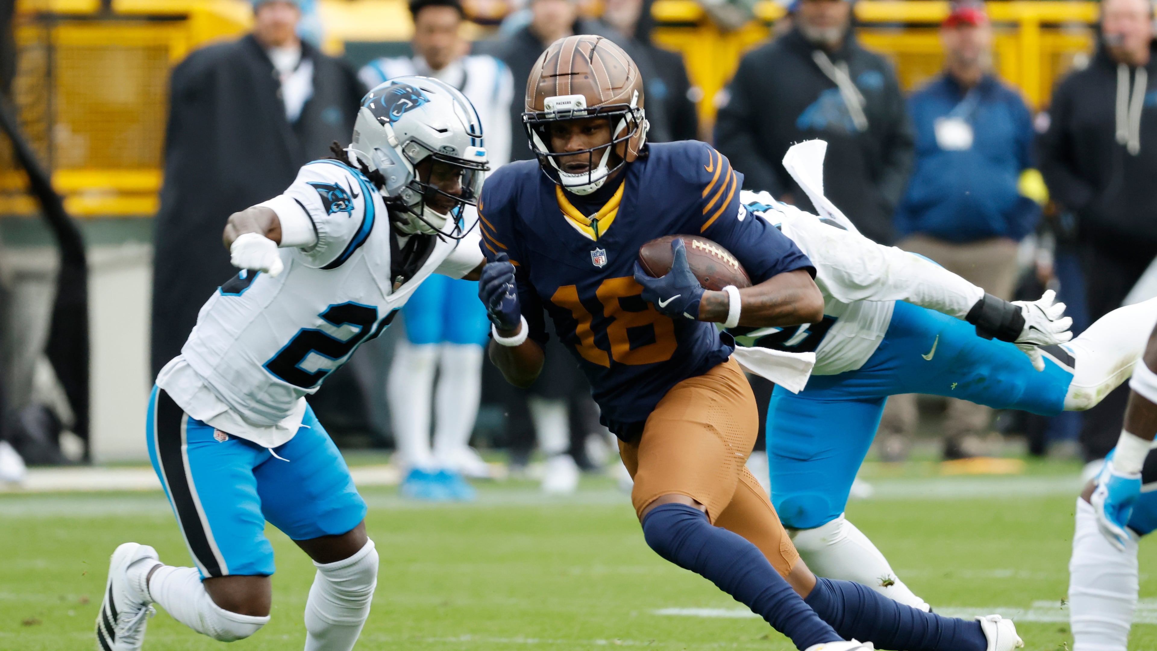 Green Bay Packers wide receiver Malik Heath (center) runs against Carolina Panthers cornerback Chau Smith-Wade (left) during the second half of an NFL football game Sunday, Nov. 2, 2025, in Green Bay, Wis. (Mike Roemer/AP)