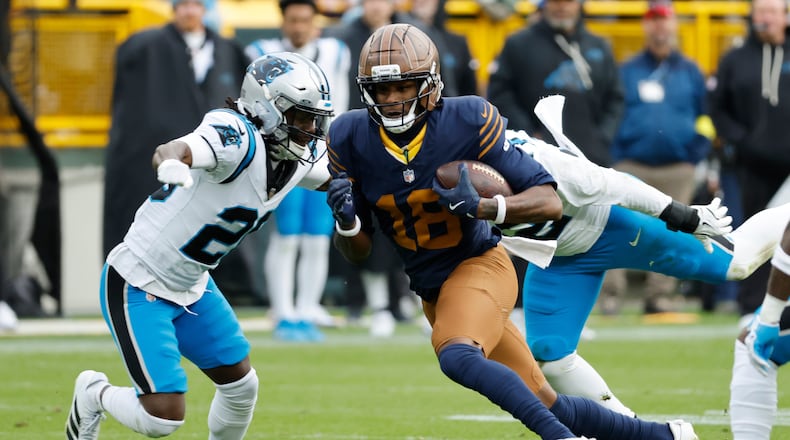 Green Bay Packers wide receiver Malik Heath (center) runs against Carolina Panthers cornerback Chau Smith-Wade (left) during the second half of an NFL football game Sunday, Nov. 2, 2025, in Green Bay, Wis. (Mike Roemer/AP)