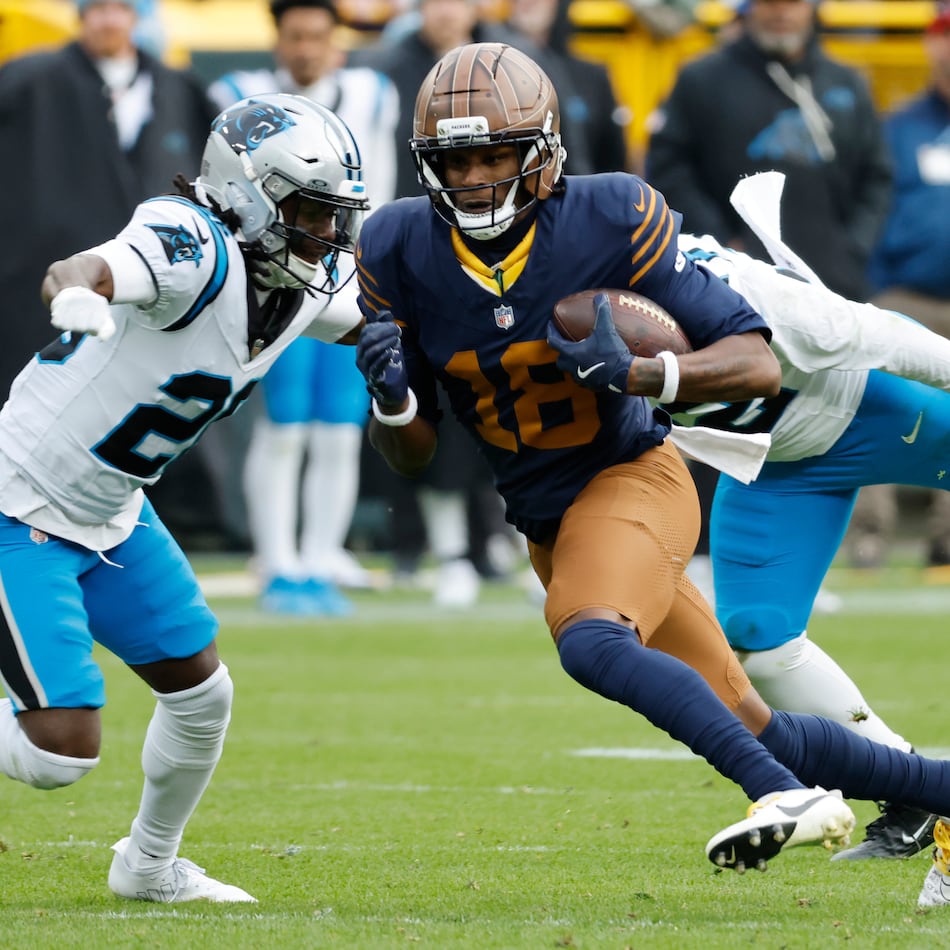 Green Bay Packers wide receiver Malik Heath (center) runs against Carolina Panthers cornerback Chau Smith-Wade (left) during the second half of an NFL football game Sunday, Nov. 2, 2025, in Green Bay, Wis. (Mike Roemer/AP)