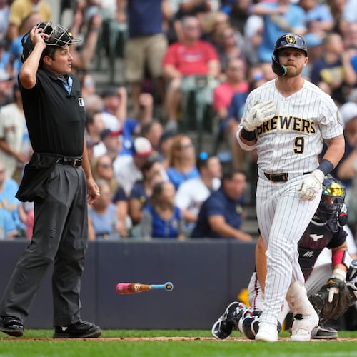 Milwaukee Brewers' Jake Bauers flips his bat after hitting a two-run home run during the third inning of a baseball game against the Atlanta Braves, Saturday, Aug. 22, 2026, in Milwaukee. (AP Photo/Aaron Gash)
