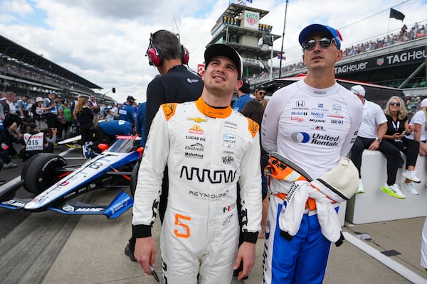 Pato O'Ward, of Mexico, left, watches with Graham Rahal during qualifications for the Indianapolis 500 auto race at Indianapolis Motor Speedway in Indianapolis, Saturday, May 17, 2025. (AP Photo/Michael Conroy)