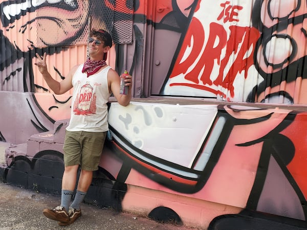 Chris Wright, also known as Chris Makes Art with his own mural. (Courtesy of Arthur Rudick)