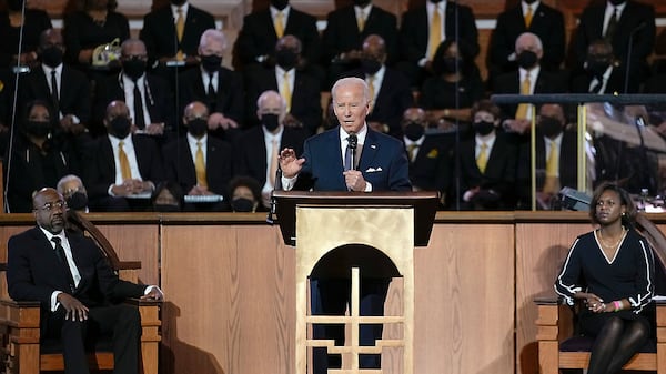 President Joe Biden speaks at Ebenezer Baptist Church in Atlanta, Sunday, Jan. 15, 2023, during a service honoring Martin Luther King Jr. Sen. Raphael Warnock, D-Ga., a senior pastor at Ebenezer Baptist Church, listens at left. (Carolyn Kaster/AP 2023)