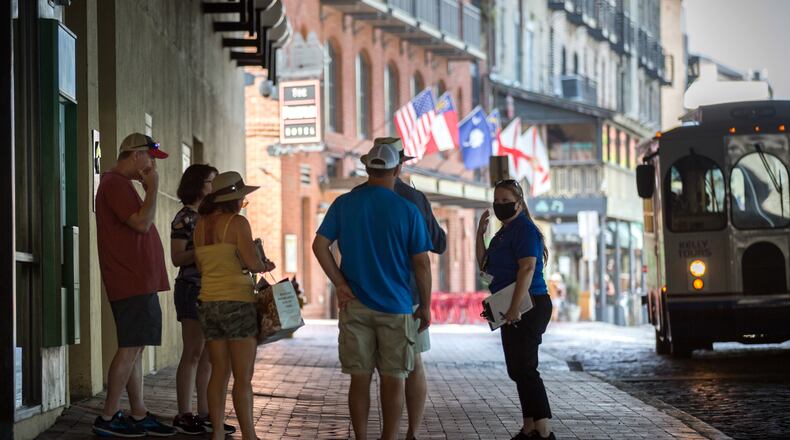 SAVANNAH, GA - Sept. 4, 2020: CoVid Resource Team member Nicole Bush, right, reminds a group of people to wear masks while visiting River Street in historic downtown Savannah. (AJC Photo/Stephen B. Morton)