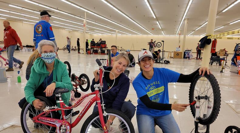 Volunteers with Bikes For Kids clean donated used bicycles, getting them "Santa ready" for North Fulton Community Charities Toyland gift market. Courtesy of Bike Alpharetta