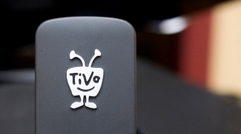 FILE - In this file photo taken March 1, 2010, a TiVo Wireless N Adapter is displayed in New York. Digital TV listing company Rovi is buying TiVo in a cash-and-stock deal valued at about $1.1 billion. Rovi Corp. said Friday, April 29, 2016 that it will pay $10.70 in cash and stock for each TiVo Inc. share. Rovi will pay $2.75 per share in cash, or about $277 million. The rest, $7.95 per share, will be paid in stock.(AP Photo/Mark Lennihan, File)