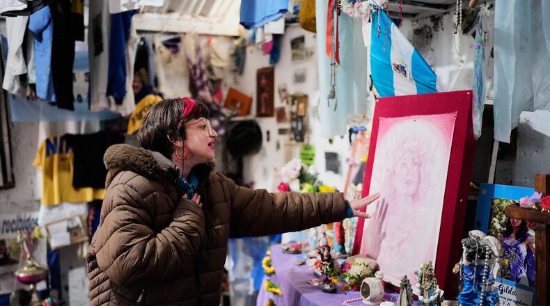 A person prays at a sanctuary dedicated to late Argentine singer Gilda on the 30th anniversary of her death in a bus crash, in Entre Rios, Argentina, Monday, Sept. 7, 2026. (AP Photo/Natacha Pisarenko)