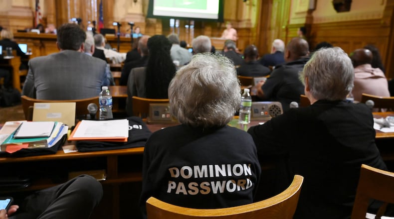 A members of audiences wearing a “Dominion Password” t-shirt sits during public comment session at the State Election Board’s final scheduled meeting of 2024 at Georgia Capitol, Tuesday, October 8, 2024, in Atlanta. (Hyosub Shin / AJC)