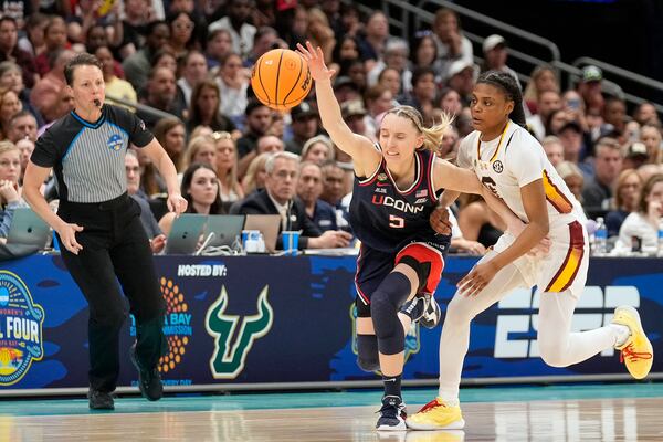 South Carolina guard MiLaysia Fulwiley (12) strips the ball from UConn guard Paige Bueckers (5) during the second half of the national championship game at the Final Four of the women's NCAA college basketball tournament, Sunday, April 6, 2025, in Tampa, Fla. (AP Photo/Chris O'Meara)