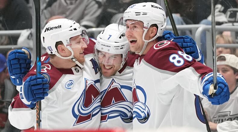 Colorado Avalanche's Devon Toews (7) celebrates his goal with Nathan MacKinnon (29) and Martin Necas (88) against the Los Angeles Kings during the third period of Game 4 in the first round of an NHL hockey Stanley Cup playoff series Sunday, April 26, 2026, in Los Angeles. (AP Photo/Scott Strazzante)