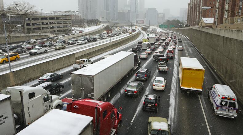 Traffic was grid locked on the connector Tuesday afternoon, Jan. 28, 2014 as many employers let their employees off all at the same time. The winter storm that paralyzed metro Atlanta and other parts of Georgia prompted Gov. Nathan Deal to declare a state of emergency Tuesday afternoon, Jan.28, 2014 for all 159 counties. In a matter of hours, snow blanketed the area. But any hopes of a winter wonderland were dashed by a more miserable reality. Take rush-hour traffic in Atlanta, add inches of slushy, slick mess and the result is gridlock on interstates in all directions. For hours, roads and interstates have remained jammed stranding some drivers, and there were too many wrecks to count Tuesday afternoon as a winter storm continued to dump snow across metro Atlanta. Many school systems dismissed early, sending some parents scrambling home. Others seemed to hit the roads, too. But it was anything but a typical commute, even by Atlanta standards. Drivers reported commutes of more than three hours. Some school buses couldn’t run routes and were forced to return to schools. And teachers and students were faced Tuesday afternoon with the real possibility of spending the night in the classroom. JOHN SPINK/JSPINK@AJC.COM