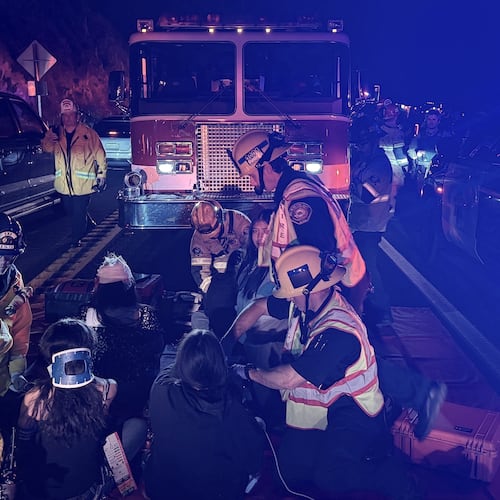 This image provided by San Bernardino County Fire shows the scene on a highway near Running Springs, Calif., where a bus overturned on Sunday, Nov. 9, 2025. (San Bernadino County Fire via AP