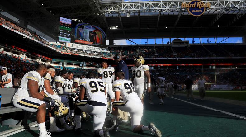 MIAMI GARDENS, FL - OCTOBER 14: The Georgia Tech Yellow Jackets huddle during a game against the Miami Hurricanes at Sun Life Stadium on October 14, 2017 in Miami Gardens, Florida.  (Photo by Mike Ehrmann/Getty Images)