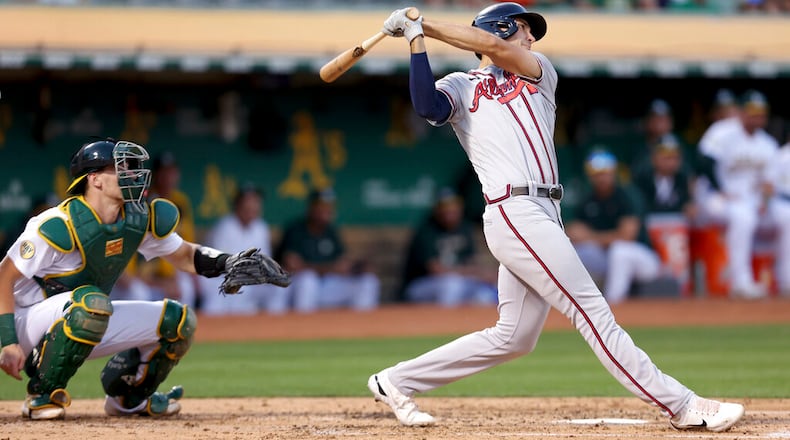 Braves first baseman Matt Olson hits a three-run home run in front of Athletics catcher Sean Murphy during the third inning Tuesday night in Oakland, Calif. (AP Photo/Jed Jacobsohn)
