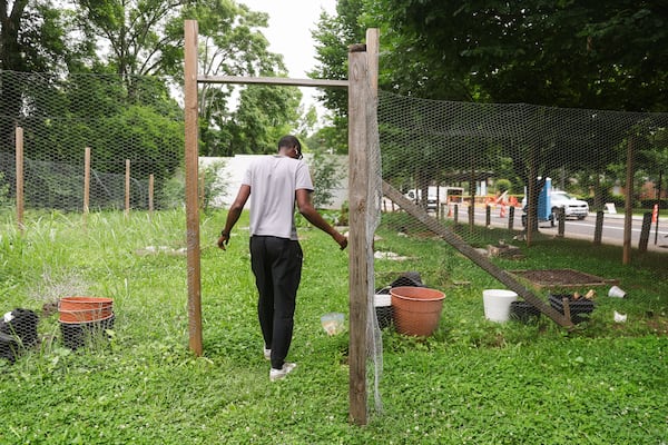 Co-Founder of Dream Builders of Atlanta Darrell Jay Johnson walks through the community garden at the Rick McDevitt Youth Center in Atlanta on Monday, June 8, 2026. A previous class of interns built the fence around the garden. (Abbey Cutrer/AJC)