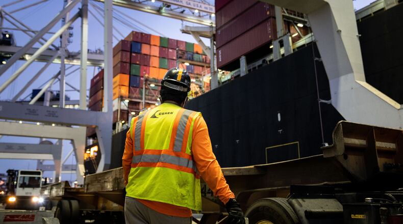 A worker waits for a crane to start moving containers from ship to shore at the Port of Savannah, in Savannah, Ga., Sept. 30, 2021. (Erin Schaff/The New York Times)