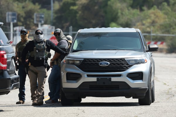 ICE agents stage outside Gate E of Dodger Stadium on Thursday, June 19, 2025. (Myung J. Chun/Los Angeles Times via AP)