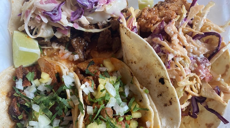 This takeout order includes Taco Cantina’s regular al pastor, super fried chicken and super Asian beef tacos. Bob Townsend for The Atlanta Journal-Constitution