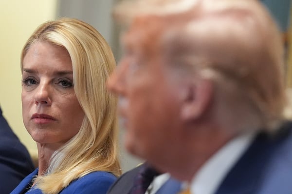 Attorney General Pam Bondi, left, listens as President Donald Trump, right, speaks during a cabinet meeting at the White House, Tuesday, July 8, 2025, in Washington. (AP Photo/Evan Vucci)