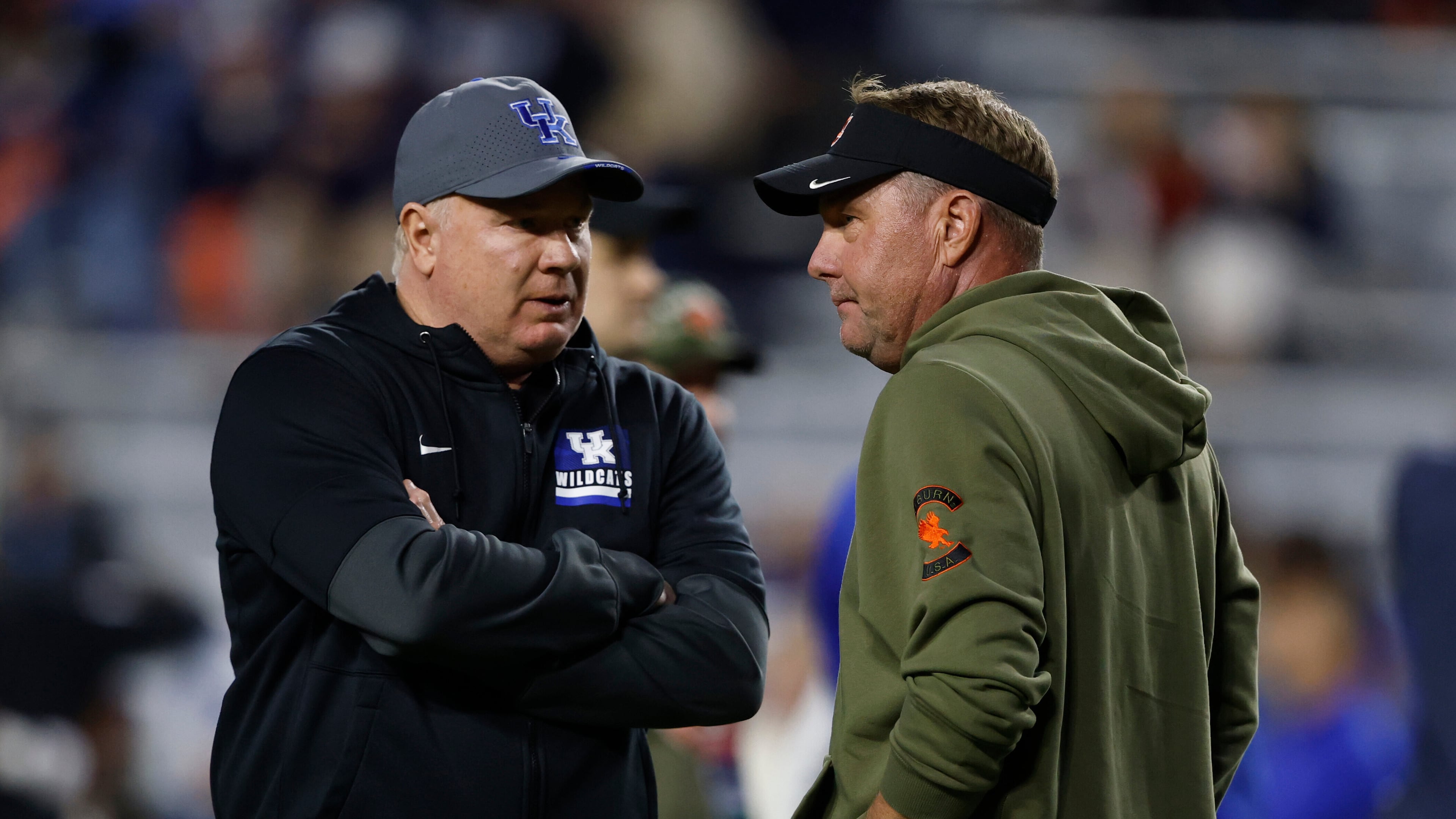 Kentucky head coach Mark Stoops talks with Auburn head coach Hugh Freeze before an NCAA college football game, Saturday, Nov. 1, 2025, in Auburn, Ala. (AP Photo/Butch Dill)