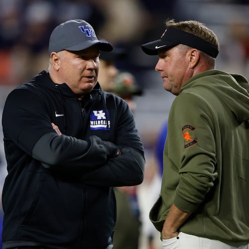 Kentucky head coach Mark Stoops talks with Auburn head coach Hugh Freeze before an NCAA college football game, Saturday, Nov. 1, 2025, in Auburn, Ala. (AP Photo/Butch Dill)