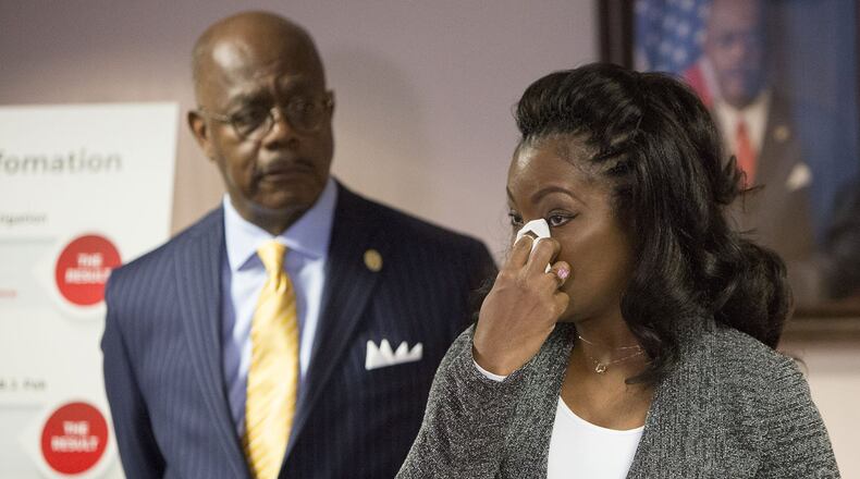 Fulton County District Attorney Paul L. Howard Jr (left) listens as Monteria Robinson talks about the death of her son Jamarion Robinson. Howards announced the filing of a lawsuit against the United States Department of Justice in the death of her son during a press conference on December 28th, 2018. (Photo by Phil Skinner)