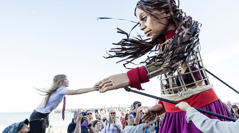 Amal shares a greeting with a young friend in Folkestone, England. Photos: courtesy: The Walk Productions