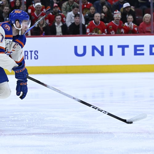 Edmonton Oilers center Connor McDavid (97) moves the puck against the Chicago Blackhawks during the first period of an NHL hockey game, Monday, Jan. 12, 2026, in Chicago. (AP Photo/Matt Marton)