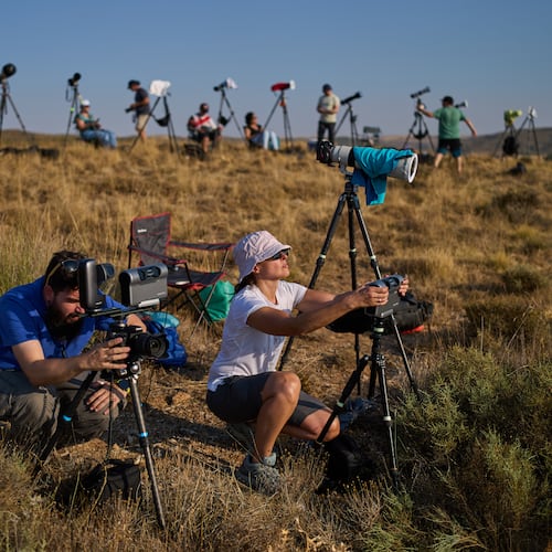 Members of the "Los Taraos" amateur astrophotography group, set up cameras to shoot a total solar eclipse in Berlanga de Duero, central Spain, Wednesday, Aug. 12, 2026. (AP Photo/Bernat Armangue)