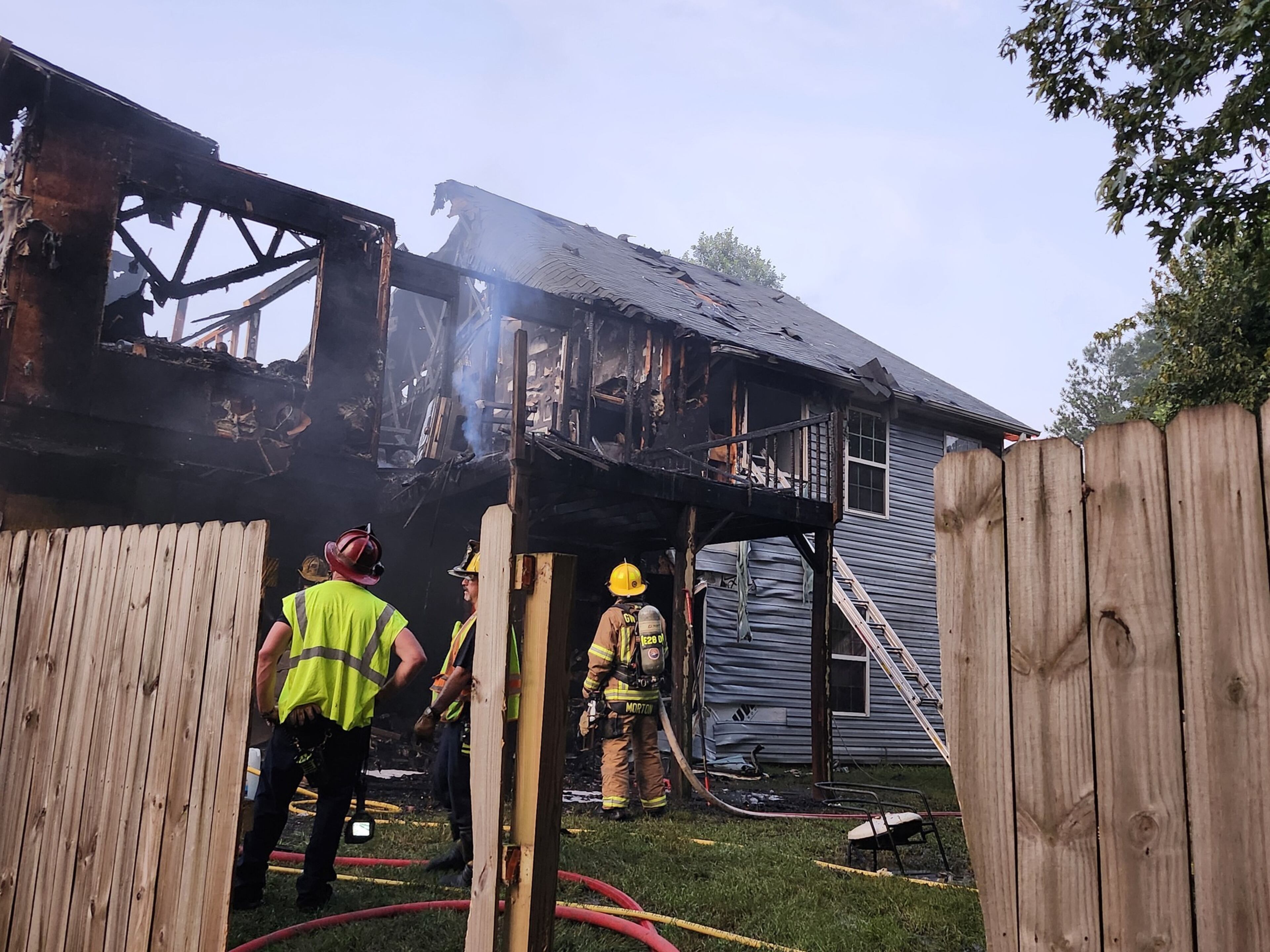 Gwinnett County firefighters had to halt rescue efforts when the roof of the house collapsed. They quickly resumed once the flames were under control. (courtesy Gwinnett County Fire and Emergency Services)