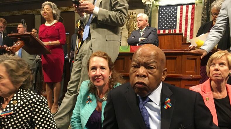 This photo provided by U.S. Rep. Chillie Pingree, D-Maine, shows Democrat members of Congress, including Reps. John Lewis, D-Ga., center, and Elizabeth Esty, D-Conn. as they participate in a June sit-down protest seeking a a vote on gun control measures on the floor of the House on Capitol Hill in Washington. Via AP