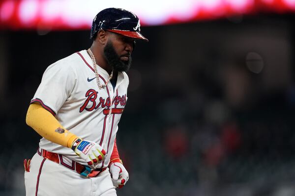 Atlanta Braves designated hitter Marcell Ozuna (20) celebrates his walk-off two-run homer against the Philadelphia Phillies in the 11th inning of a baseball game after a rain delay, Friday, April 11, 2025, in Atlanta. (AP Photo/Mike Stewart)