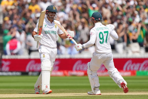 South Africa's David Bedingham, left, and Kyle Verreynne celebrate after their win in the World Test Championship final against Australia at Lord's cricket ground in London, Saturday, June 14, 2025. (AP Photo/Kirsty Wigglesworth)