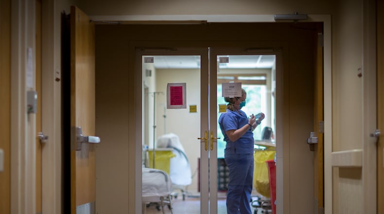 A staff member at Emanuel Medical Center in Swainsboro works in a special unit in 2020. A new multi-year CDC study has found that people in rural Georgia and nationwide are more likely to die early than those in urban areas. (Stephen B. Morton/AJC 2020 file photo)