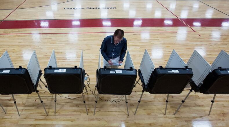 Wayne Snipes cast his ballot at Grady High School, one of 22 Atlanta public schools used as polling sites, during the primary runoff election, Tuesday, July 26, 2016. BRANDEN CAMP/SPECIAL