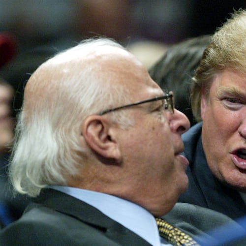 FILE - Donald Trump, right, talks to an unidentified man from the stands at Madison Square Garden during the New York Knicks game against the Dallas Mavericks on Jan. 11, 2006, in New York. (AP Photo/Kathy Willens, File)