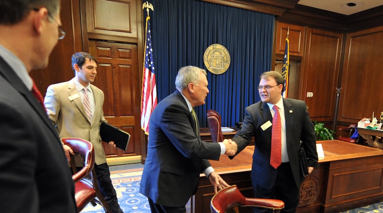 Gov. Nathan Deal greets state Rep. Jason Spencer, R-Woodbine, before meeting with local officials in Spencer’s district in Camden County in 2011. Brant Sanderlin / bsanderlin@ajc.com