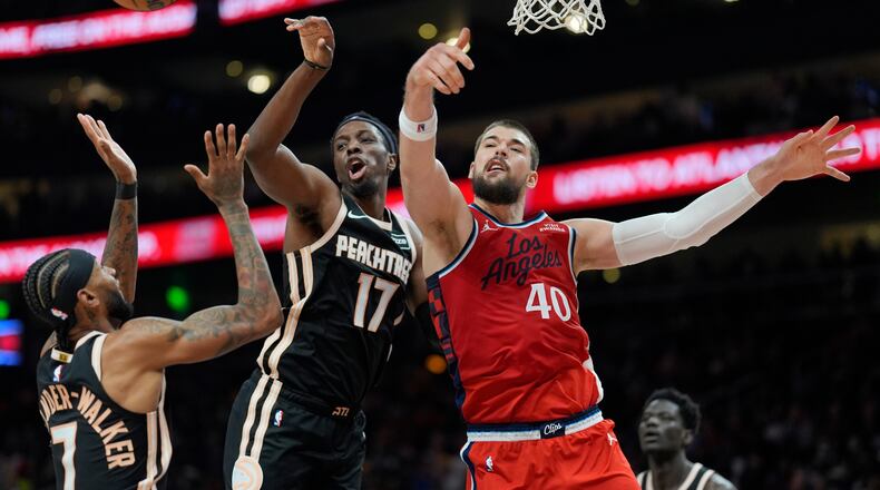 Los Angeles Clippers center Ivica Zubac (40) and Atlanta Hawks forward Onyeka Okongwu (17) vie for a loose ball during the first half of an NBA basketball game, Wednesday, Dec. 3, 2025, in Atlanta. (Mike Stewart/AP)