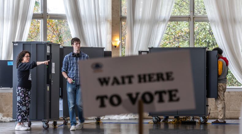 Poll worker Sarah Zaslaw (left) directs voters at the Park Tavern in Atlanta on Tuesday, Nov. 5, 2024. (AJC File)