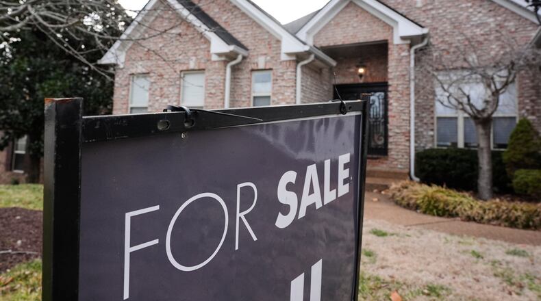 A "for sale" sign is posted outside a home in Nashville, Tenn., on Tuesday, Feb. 10, 2026. (AP Photo/George Walker IV)