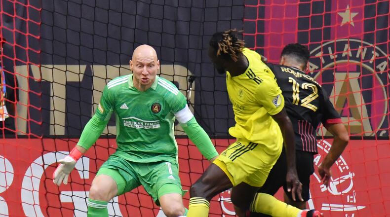 August 28, 2021 Atlanta - Atlanta United's goalkeeper Brad Guzan (1) blocks the shot by Nashville SC's forward Rodrigo Pineiro (11) as Atlanta United's defender Miles Robinson (12) defenses during the first half in a MLS soccer match at at Mercedes-Benz Stadium in Atlanta on Saturday, August 28, 2021. (Hyosub Shin / Hyosub.Shin@ajc.com)